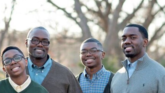Fathers and sons standing together outdoors