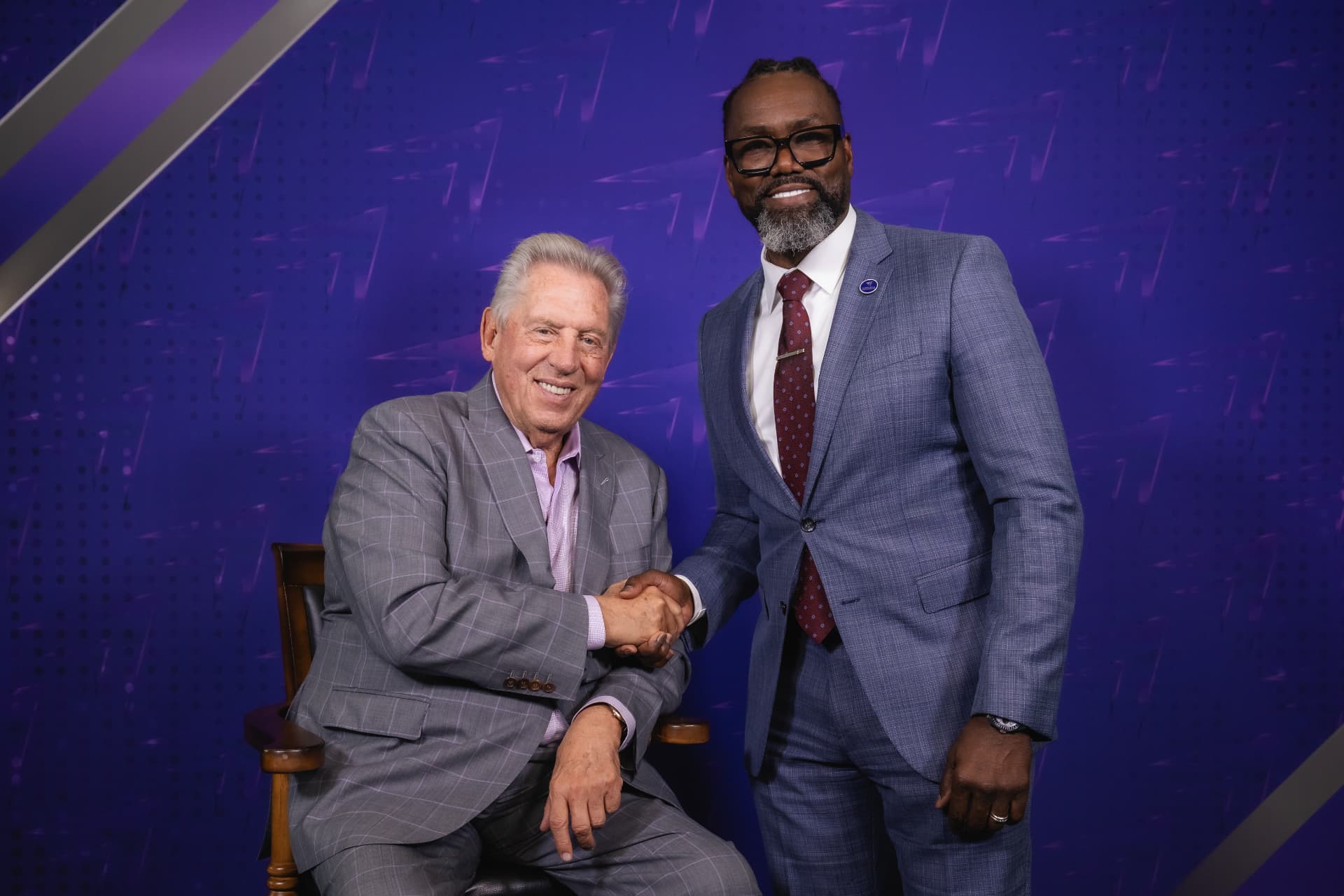Bernard P. Waller shaking hands with John Maxwell at a John Maxwell Team event